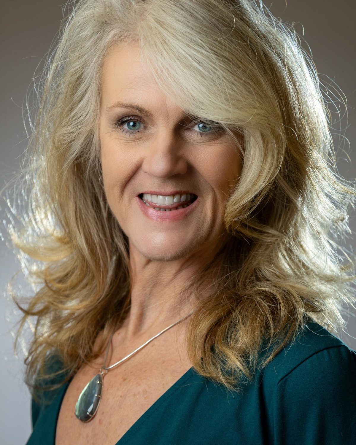 Jill McCulloch in a teal top, smiling straight at you